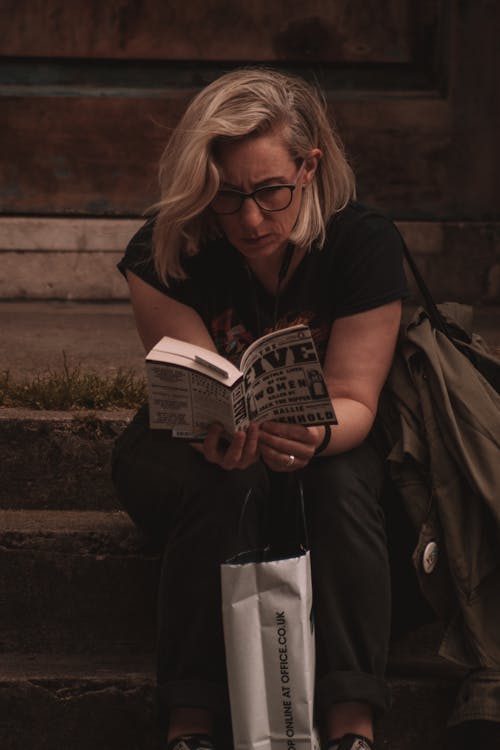 Woman in Black Shirt Reading a Book