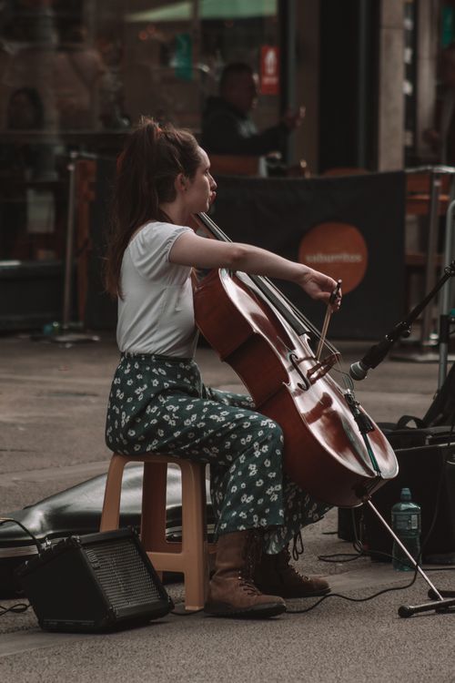 Free Young woman playing cello on a street in Dublin, Ireland, showcasing musical talent. Stock Photo