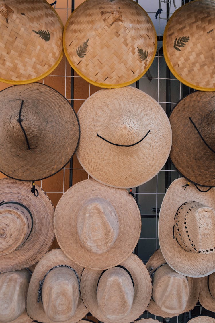 Straw Hats Hanging On Market