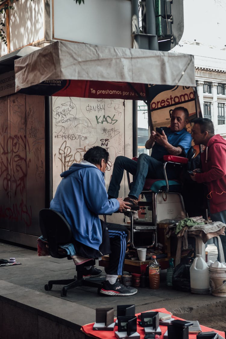 Man Cleaning Shoes On A Street