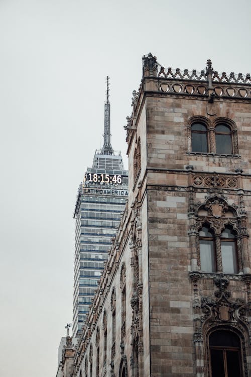 Old Building Beside a Skyscraper