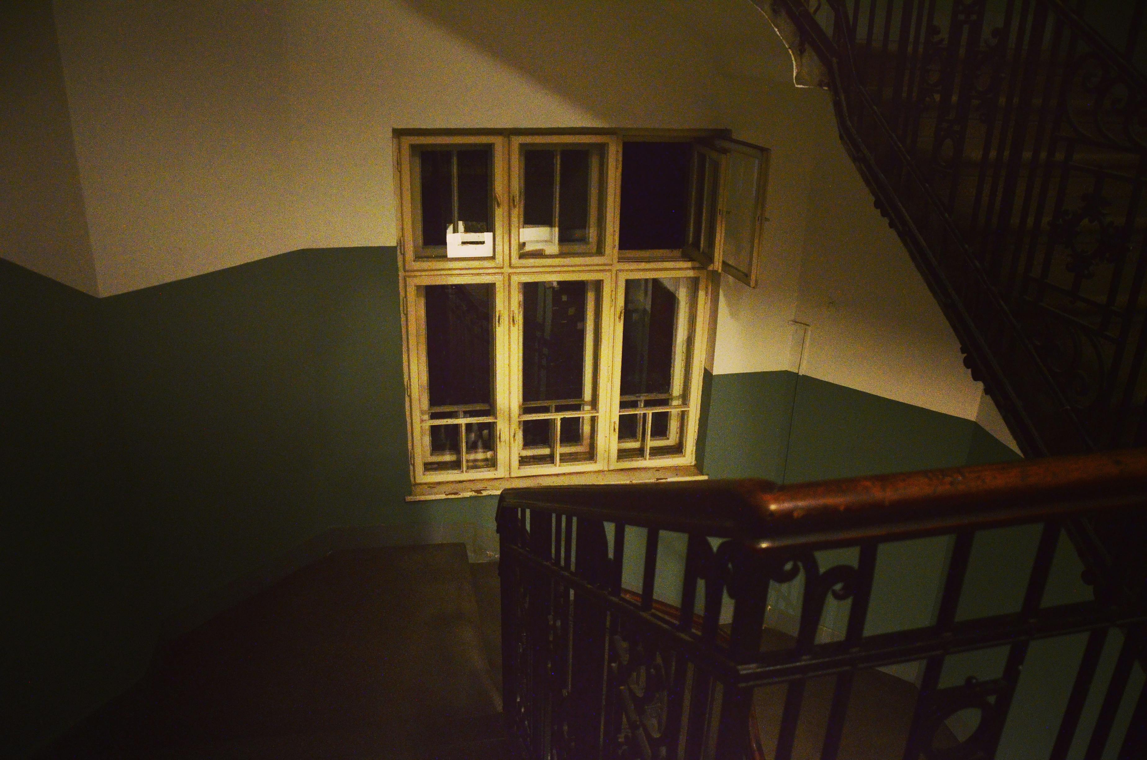 renter signing lease in vintage building stairwell - chicago historic building apartments
