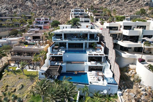Aerial view of stunning modern villas in Cabo San Lucas with ocean views.