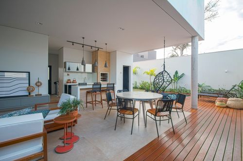 Free Contemporary open-plan patio with kitchen and seating area, modern design. Stock Photo