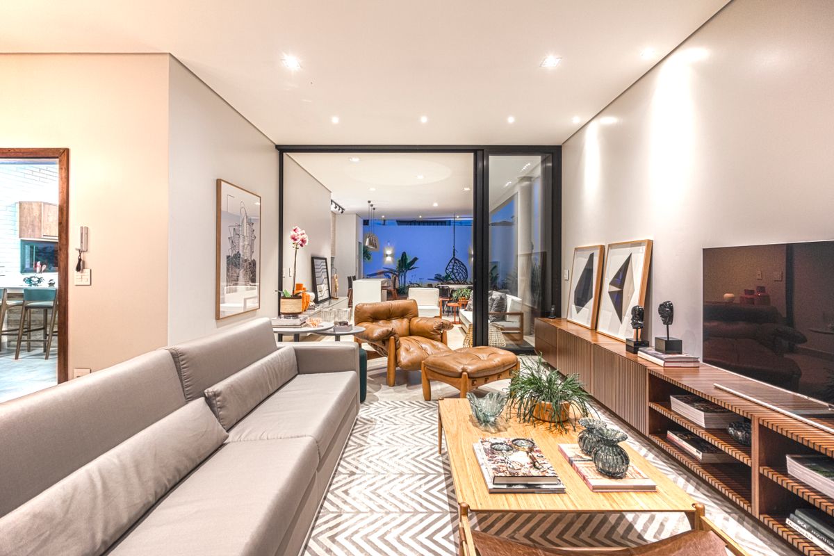 Stylish modern living room with furniture, lighting, rug and elegant decor