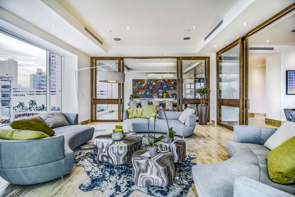 Refined sunlit living room designed by Studio Miel in Miami, FL