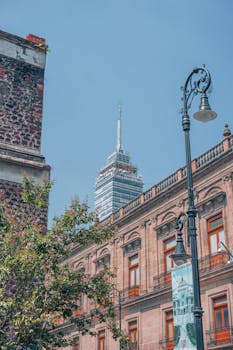 Low-angle shot of Torre Latinoamericana with historic buildings in Mexico City.