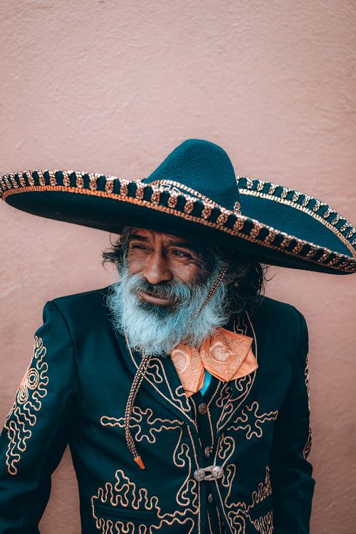 Free Portrait of an elderly man wearing traditional mariachi clothing with a sombrero, embodying Mexican culture. Stock Photo