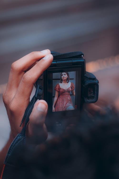 Person Holding a Black Camera