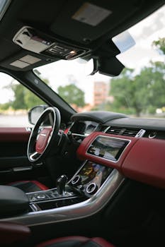 Luxury SUV interior featuring leather seats and a modern dashboard with touchscreen display.