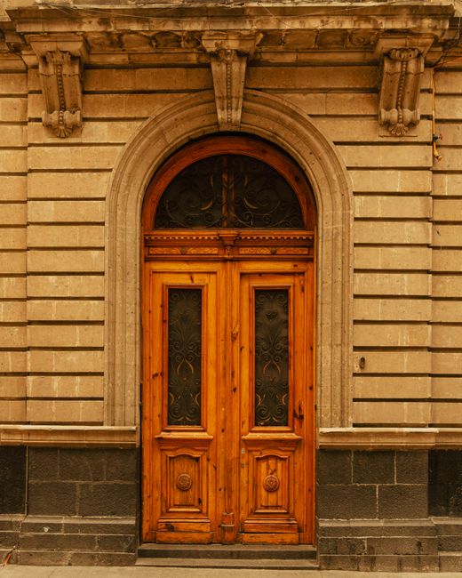 Explore this rustic wooden entrance in Mexico City, showcasing classic architectural elements.