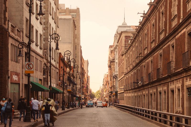 Urban street view of Ciudad de México with pedestrians and vintage architecture.