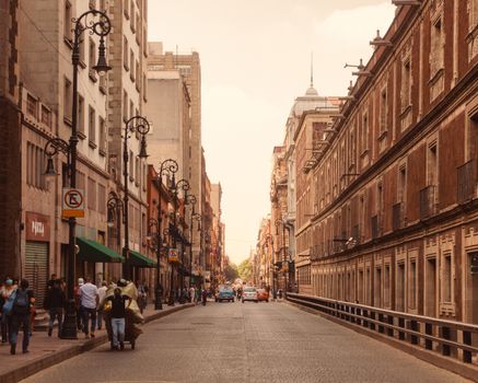 Urban street view of Ciudad de México with pedestrians and vintage architecture.
