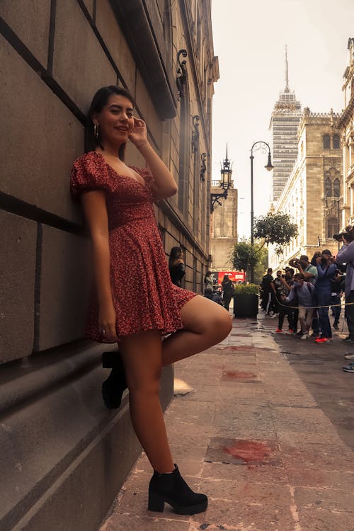 Woman in a Dress Leaning on a Wall