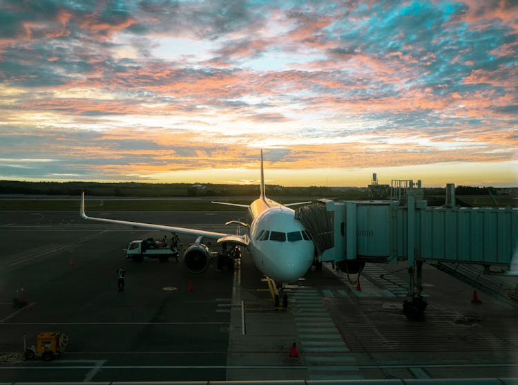 Airplane On Airport At Sunset