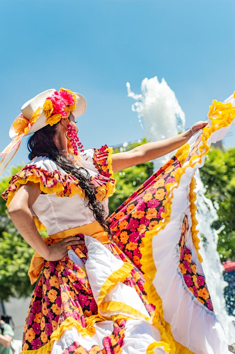 Woman In Floral Dress And White Hat Dancing