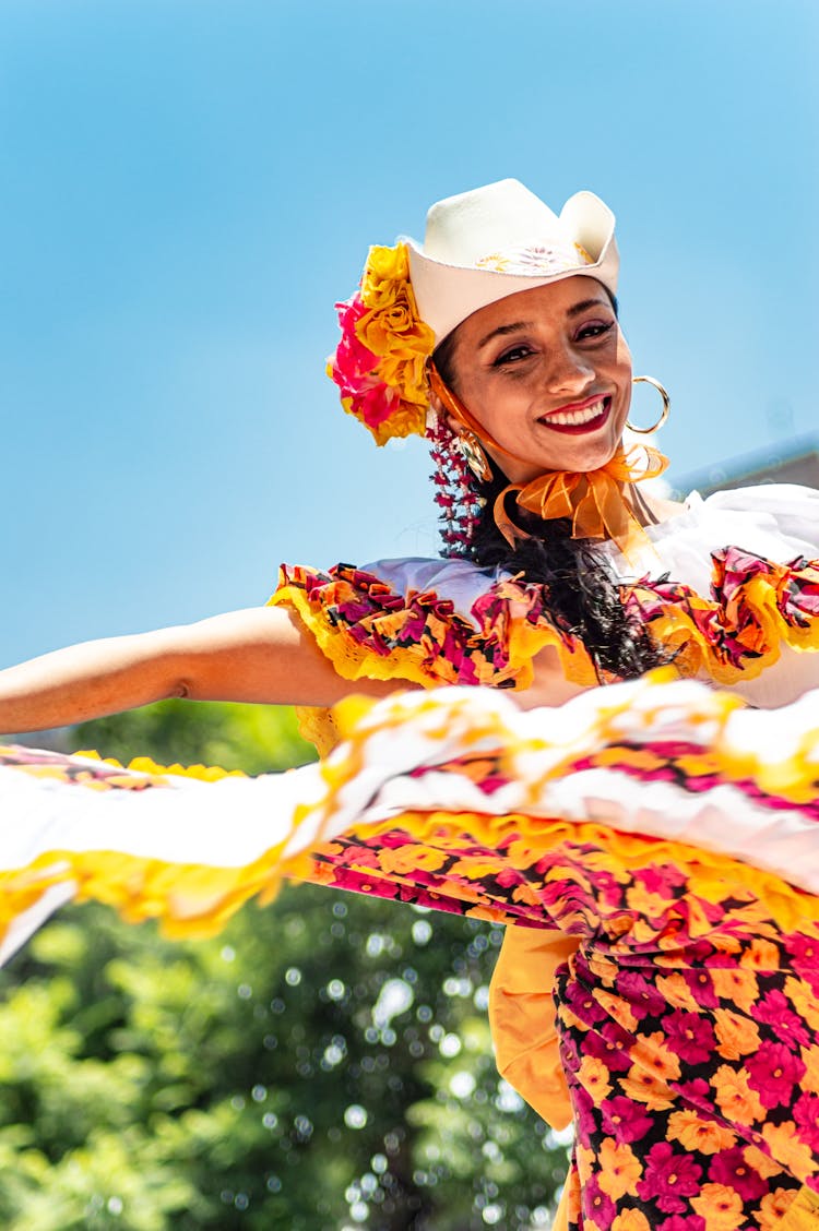 Young Woman In A Floral Pattern Dress Dancing 