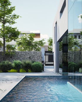 Contemporary house with pool and lush greenery in a serene setting.