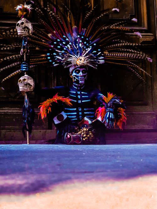 Free A vibrant depiction of an Aztec warrior in traditional attire with a feathered headdress and skull sceptre. Stock Photo