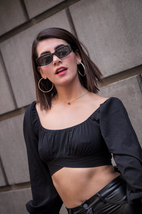 A Woman in a Crop Top Wearing Hoop Earrings 