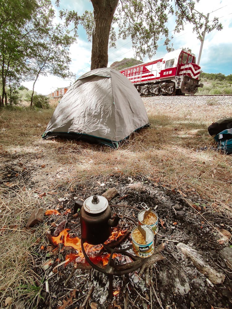 Kettle And Canned Goods Near Gray Tent