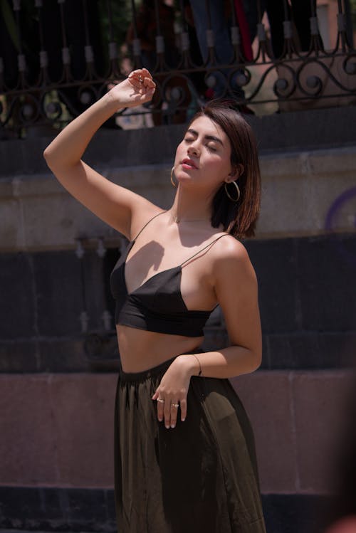 A Woman Wearing Black Bralette and Brown Skirt