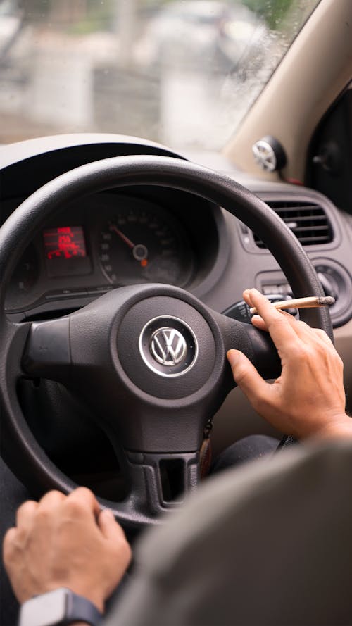Person Holding Black Volkswagen Steering Wheel