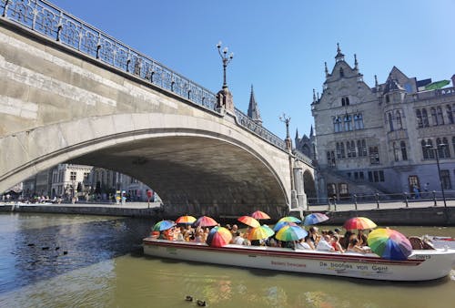 A Group of People Riding on Boat on River Under St. Michael's Bridge in Gent, Belgium