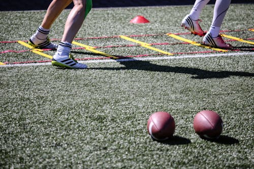 Players Legs behind Balls on Grass