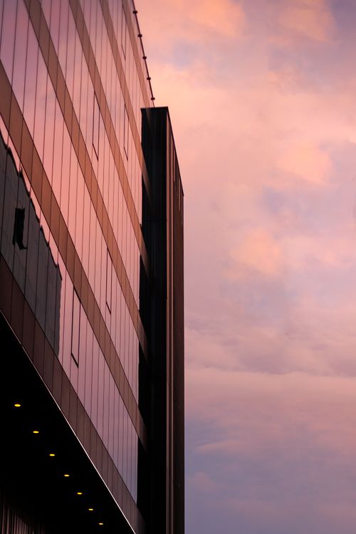 Free A modern high-rise building in Iași, Romania captured during a stunning sunset. Stock Photo