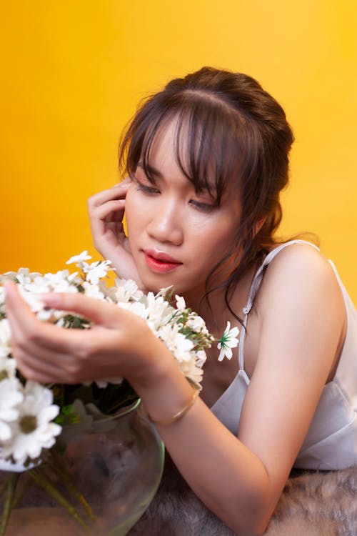 Beautiful Woman looking in White Flowers 