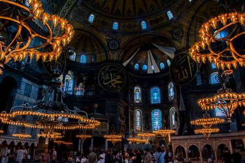 Free Stunning interior of Hagia Sophia featuring ornate chandeliers and Islamic architecture. Stock Photo