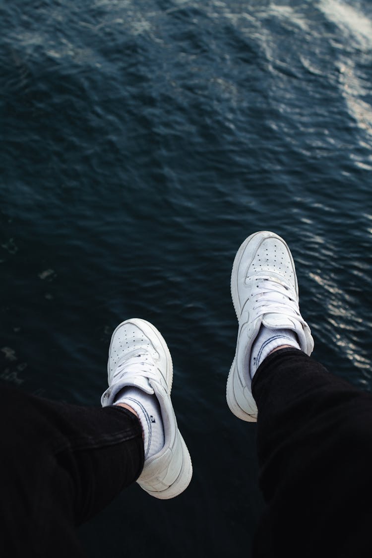 Men Legs Hanging Above Water