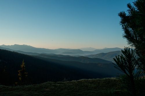Free A tranquil view of rolling mountains at dawn, capturing the beauty of nature's landscape. Stock Photo