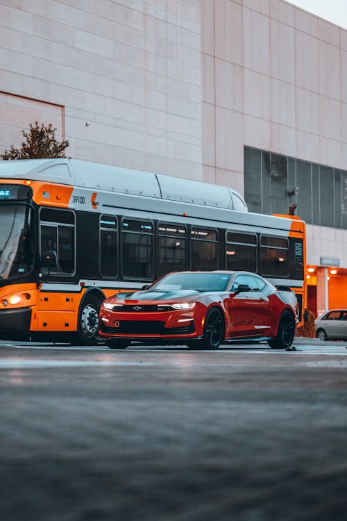 Chevrolet Camaro and a Bus on a City Street 
