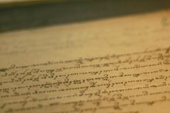 Close-up of an antique book page with cursive writing and aged paper texture.