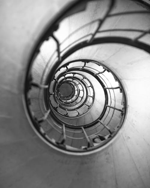 Grayscale Photo of Spiral Staircase