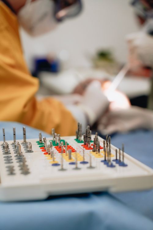 Free Close-up of dental tools with a blurred dentist background, illustrating a professional clinic environment. Stock Photo