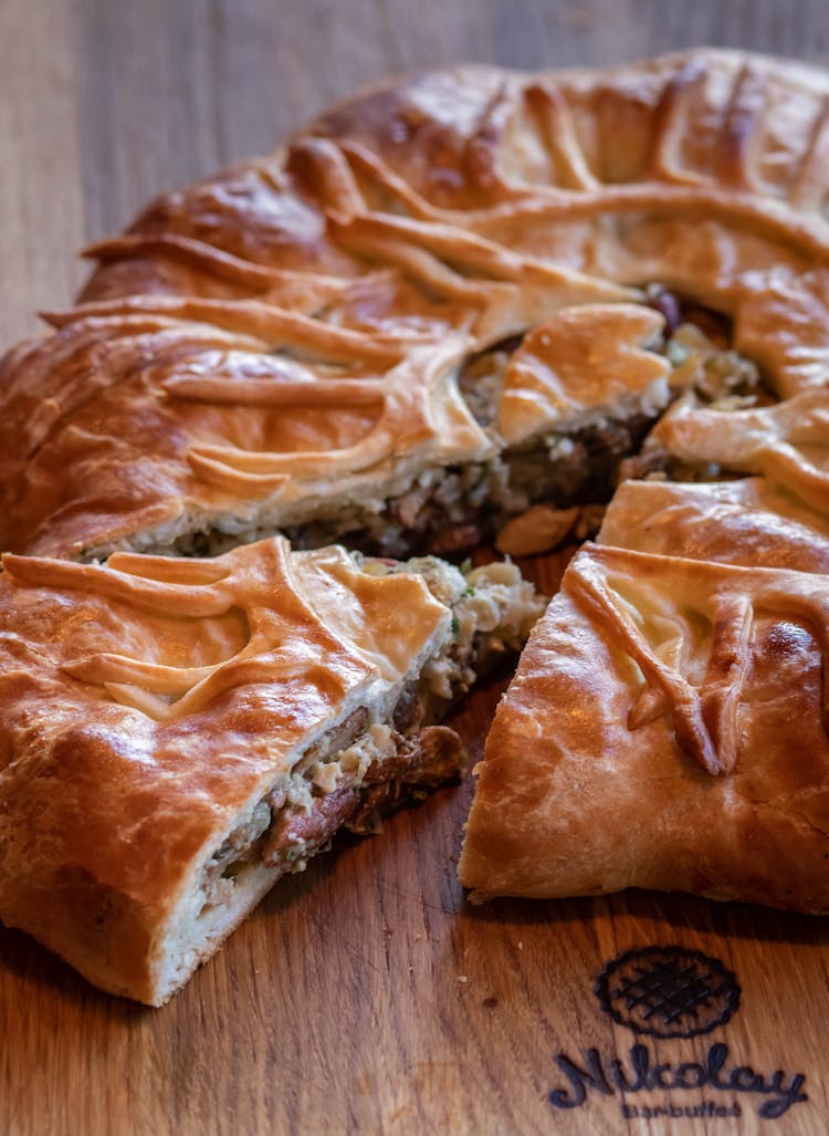 Delicious Meat Pie With Mushrooms On Wooden Table In Cafe