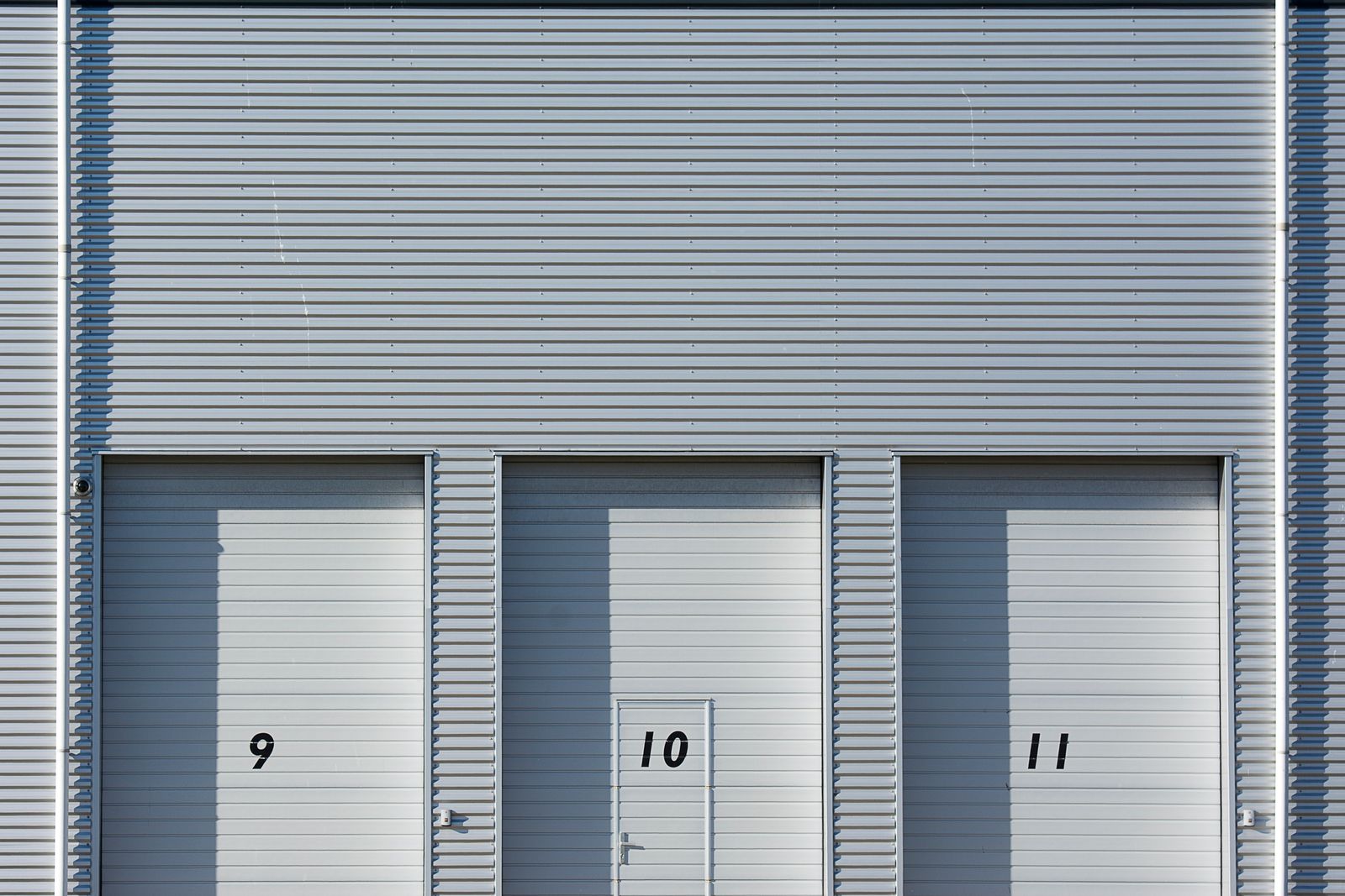 Numbered small-bay units with roll-up doors