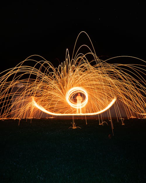 Sparkling Lights around Man at Night