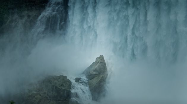 Explore the powerful waterfall cascading with mist in Toronto, Canada, a natural wonder captured in serene detail.
