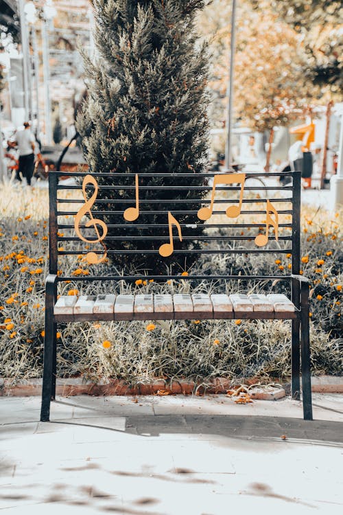 A Steel Framed Bench with Music Notes on Back Rest