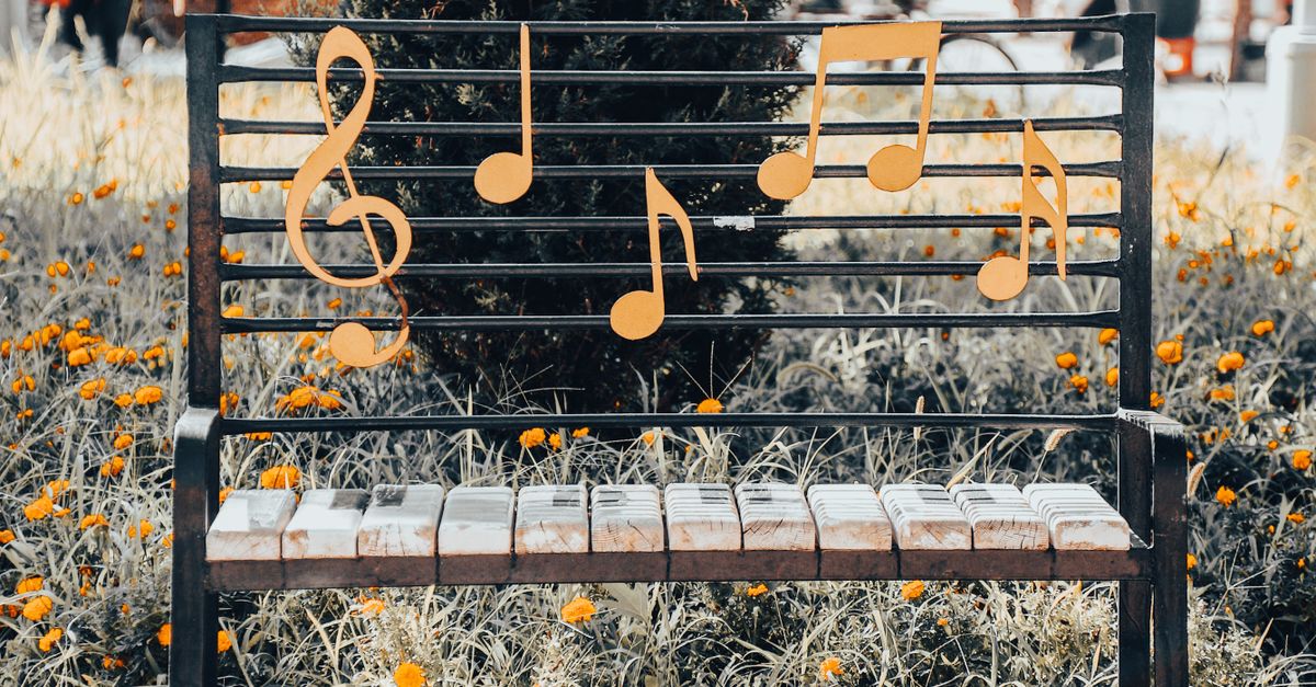 A Steel Framed Bench with Music Notes on Back Rest · Free Stock Photo