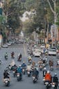 Back View of People Riding Motorcycle on Road