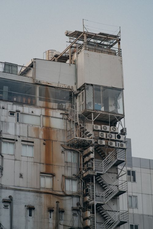 Free Rusty urban building with external structures in Ho Chi Minh City, Vietnam. Stock Photo