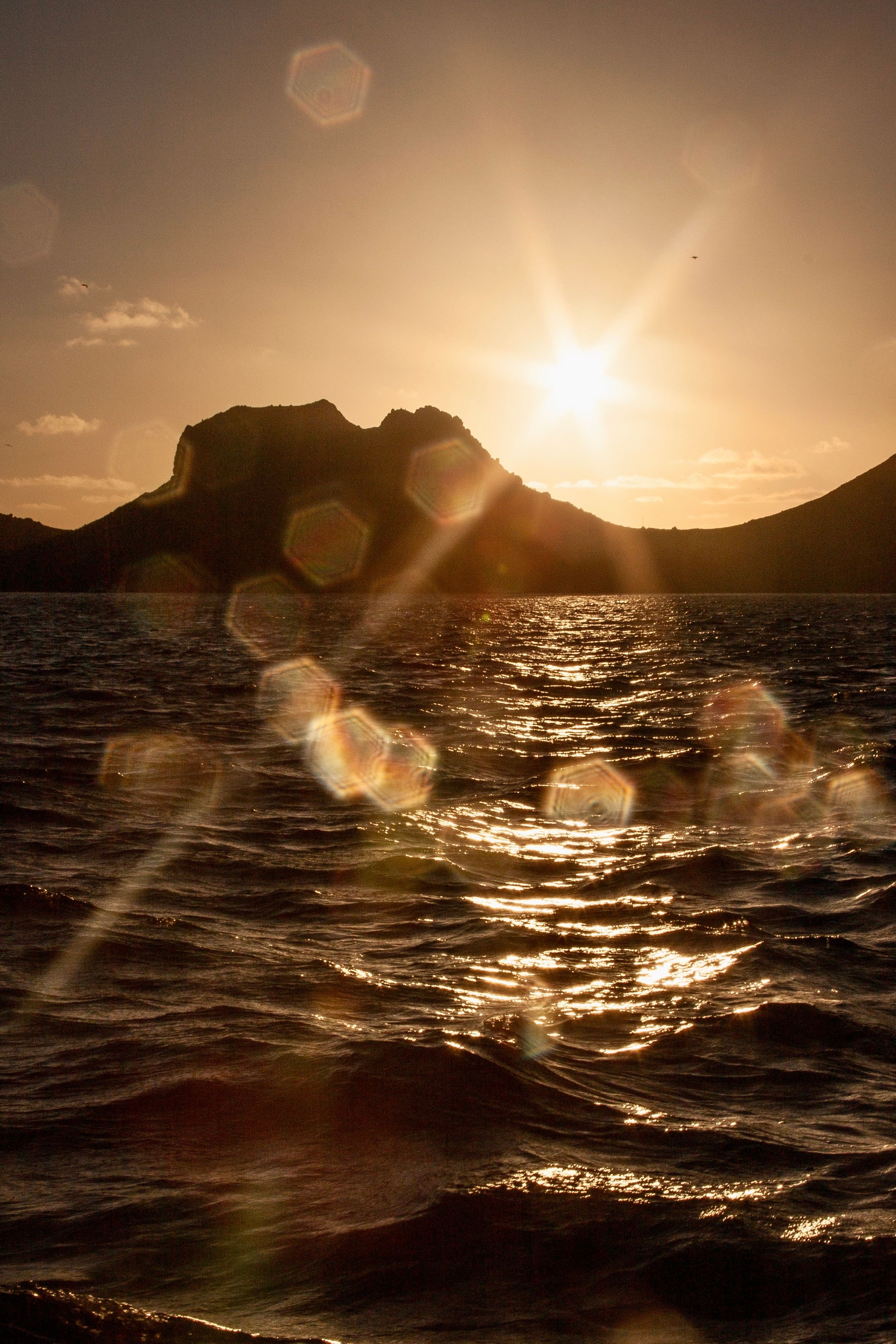 Silhouette of Mountain Near Body of Water during Sunset · Free Stock Photo