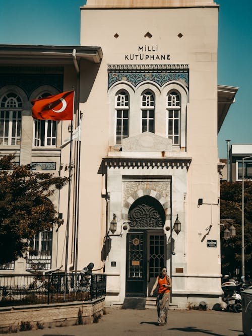Person walking in Front of İzmir National Library
