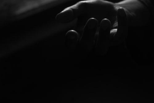 Free A dramatic black and white close-up of an open hand in soft lighting. Stock Photo