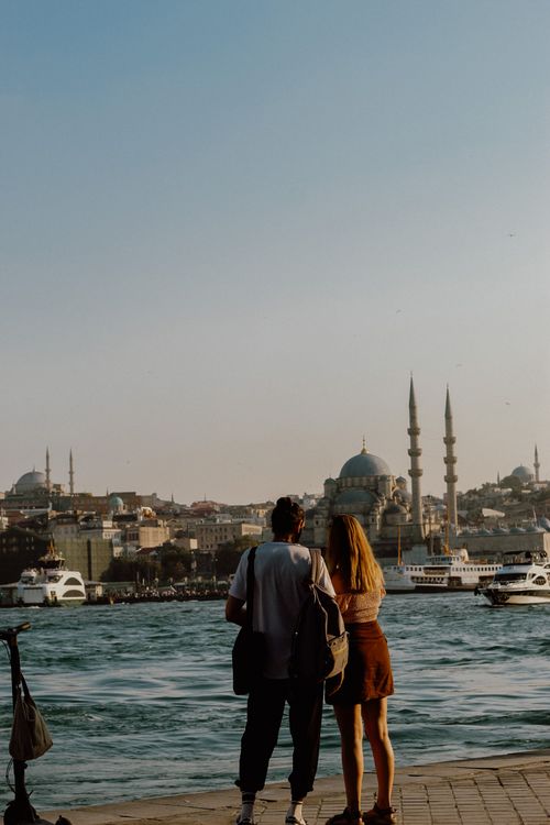 Free A couple standing by the Bosphorus in Istanbul, experiencing a romantic moment by the seaside. Stock Photo